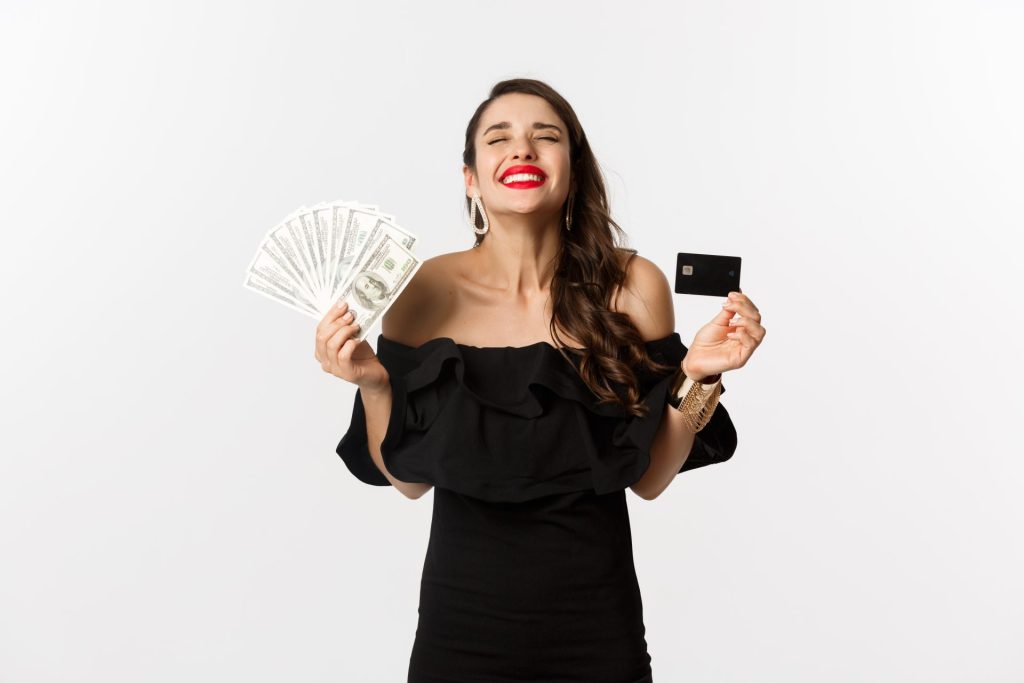 Beauty Shopping Concept Satisfied Young Woman Stylish Dress Looking Pleased Holding Credit Card Money Standing White Background