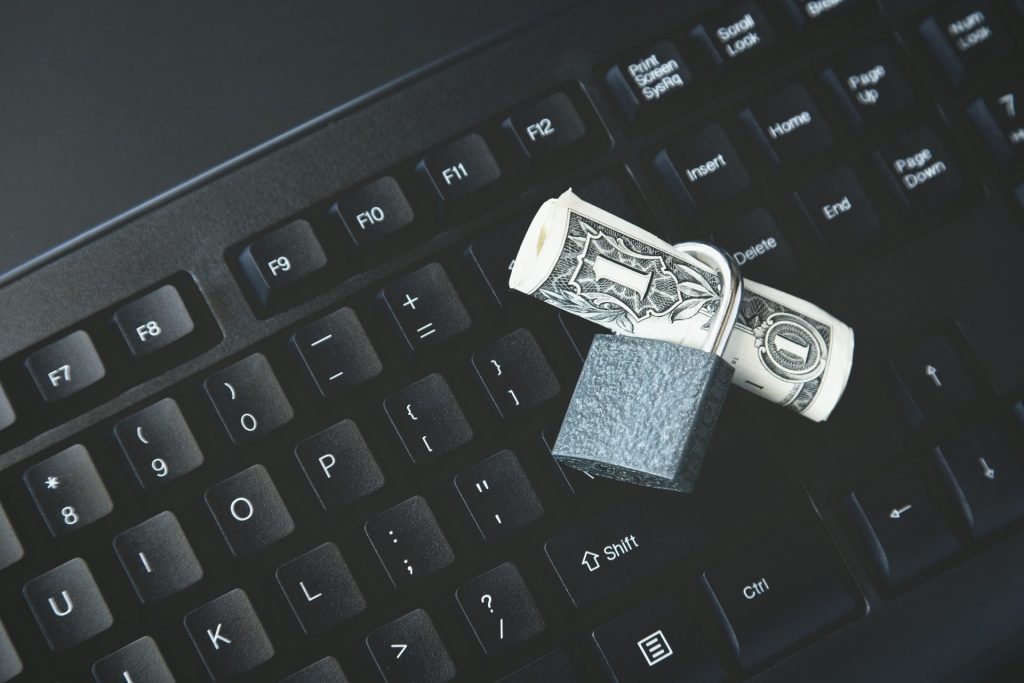 High Angle Shot Lock Around Dollar Bill Black Laptop