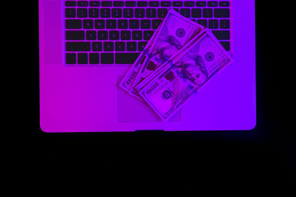 Laptop Paper Money Neon Lighting Top View